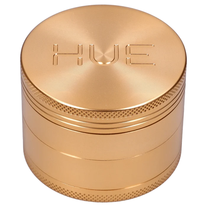 Front view of the Hue 3-Stage Grinder in champagne gold, showcasing its cylindrical, multi-tiered design.