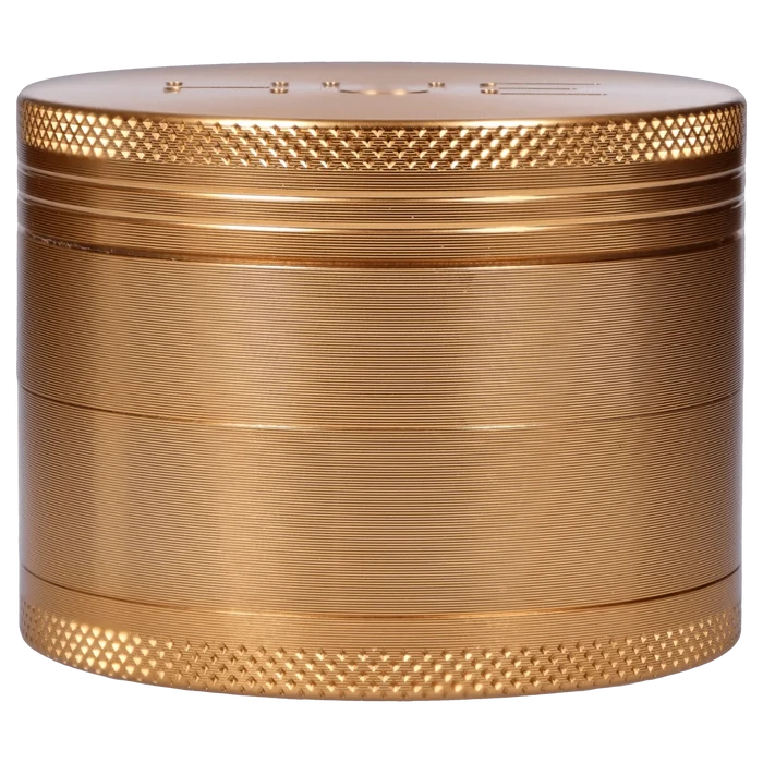 Front view of the Hue 3-Stage Grinder in champagne gold, showing its textured, cylindrical design.