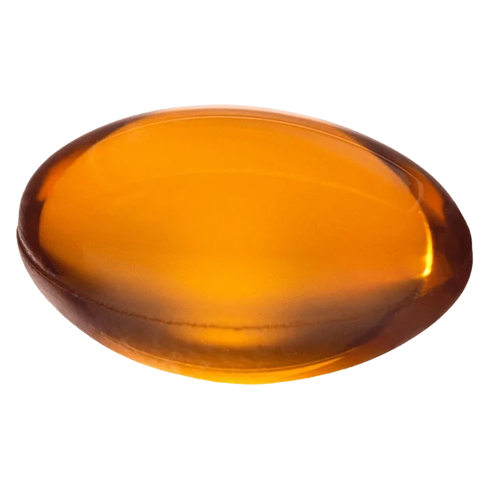 Top-down close-up of a glossy amber softgel labeled Mega Packs Bal THC:CBD 1:1, shown against a plain white background.
